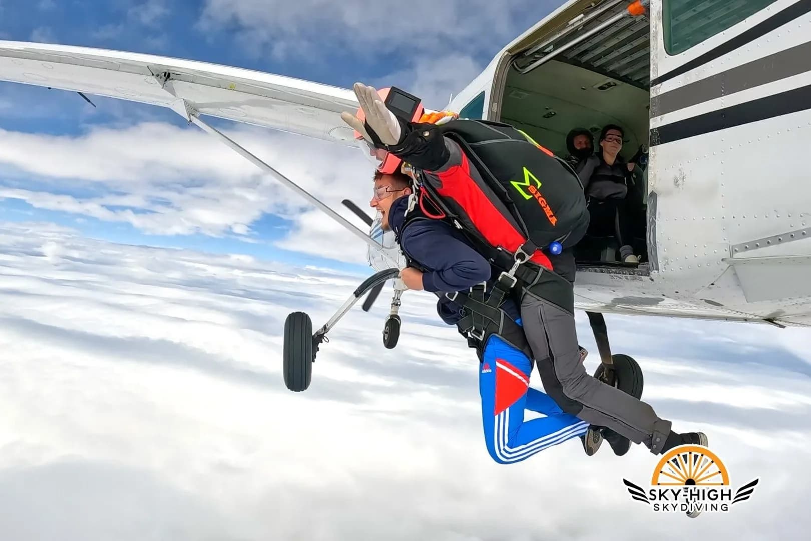 Stephen Laszlo leaving the aircraft in tandem freefall above cloud